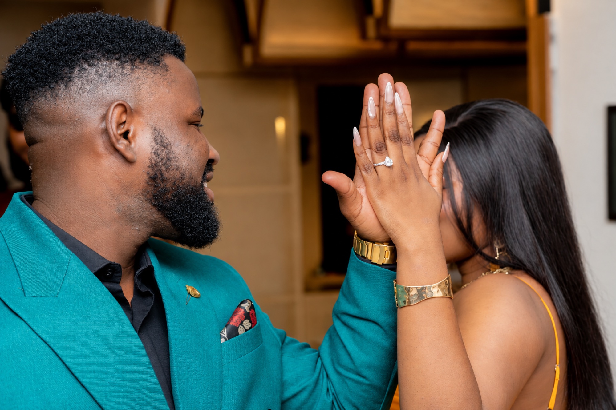 Elisha and Oyiza with their hands together, showing an engagement ring